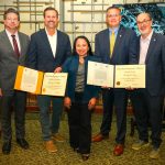 Award winners stand with Reclamation leadership team and display their awards