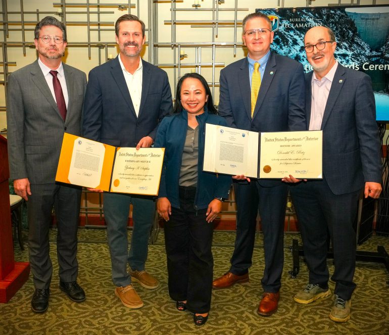 Award winners stand with Reclamation leadership team and display their awards