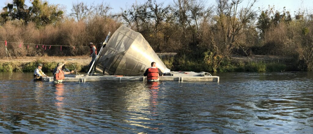 people working on an object in water