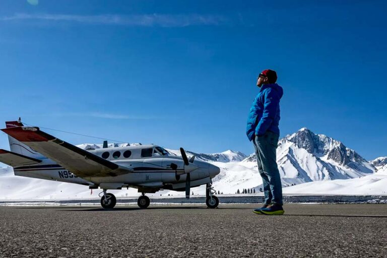 a person standing next to an airplane