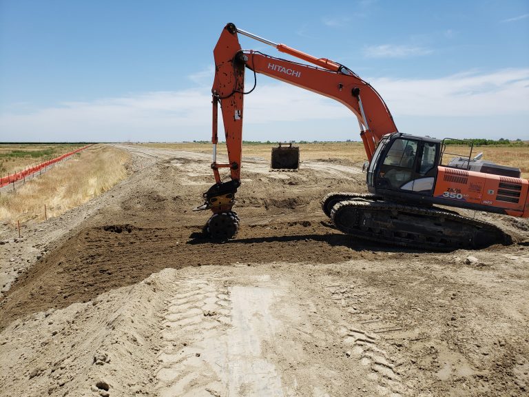 crane digging up dirt
