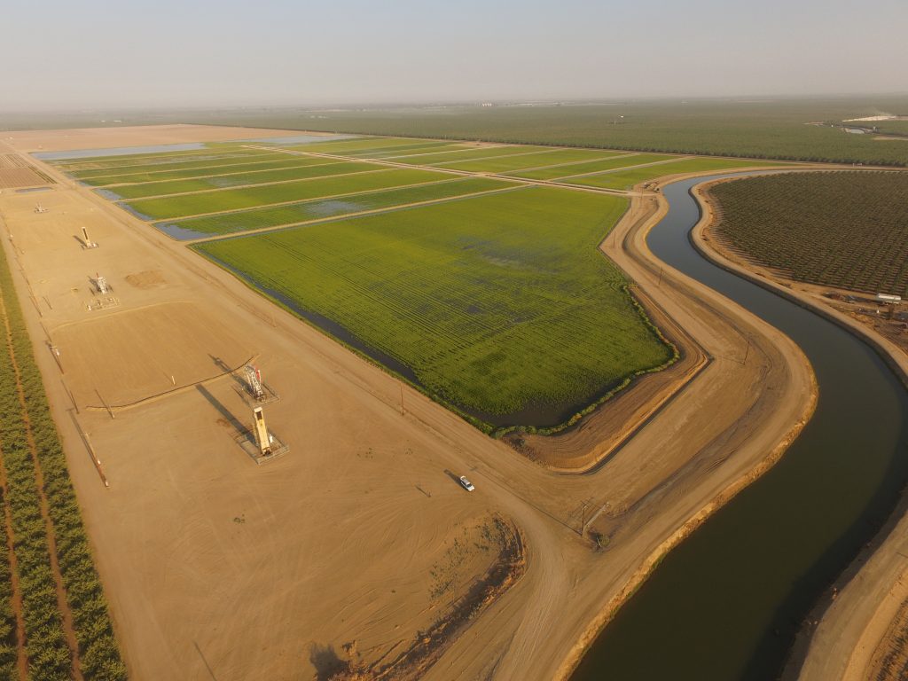 An aerial view of the Kimberlina Road Groundwater Recharge and Banking Facility showing vast swaths of farmland alongside a canal.