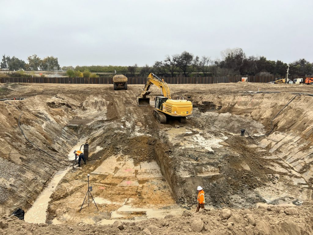 Construction crews drill test piles that will be used to support project components.