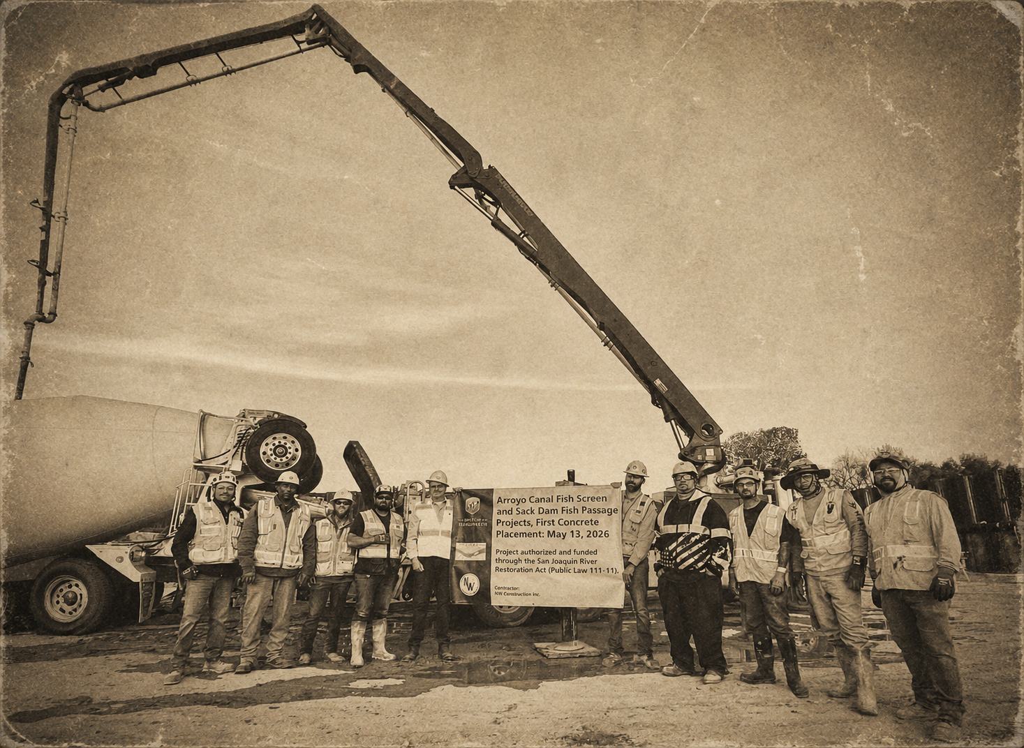 Construction crews pose for a photo in front of a cement mixer to commemorate the first placement of concrete for the Arroyo Canal Fish Screen and Sack Dam Fish Passage Projects on May 13, 2026.